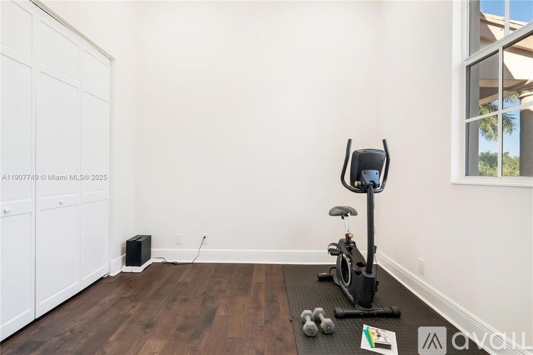 A room with a stationary bike and a speaker.