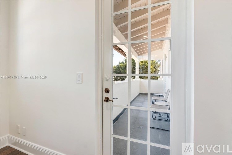A white door with a glass window and a white wall.