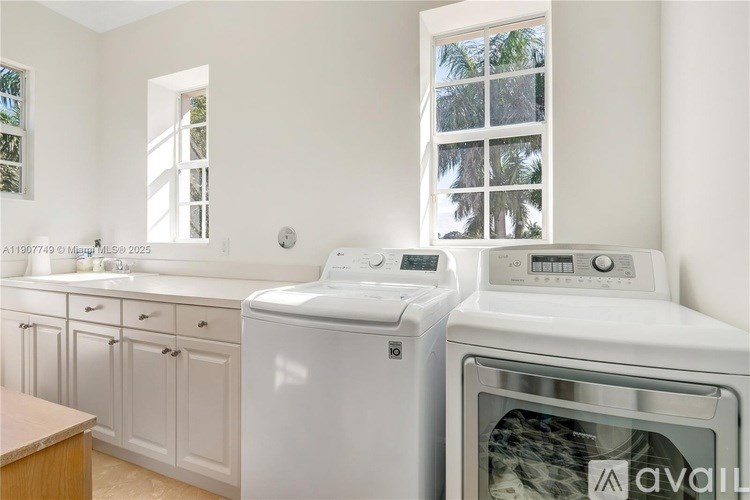 A white washing machine and dryer in a kitchen.