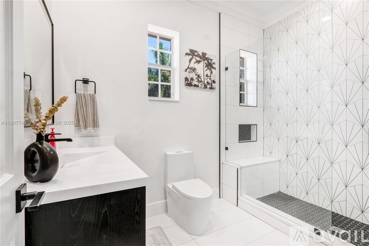 A modern bathroom with a black and white color scheme.
