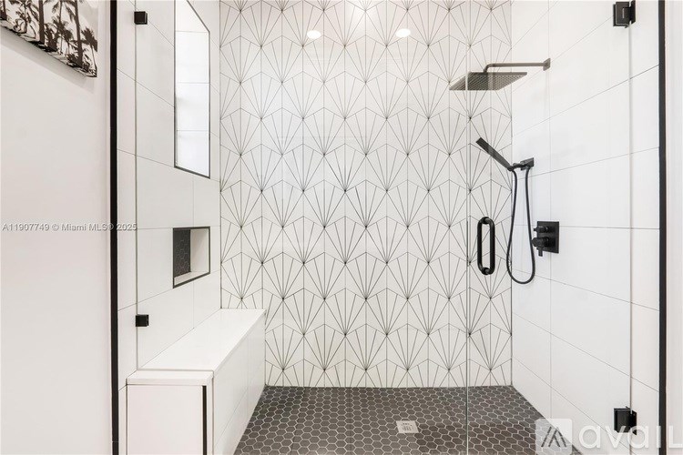 A modern bathroom with a shower area and a white bathtub.
