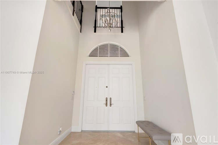 A white door with a glass window above it and a bench in front of it.