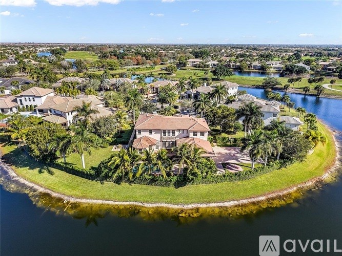 A bird's eye view of a gated community with a large house in the center.