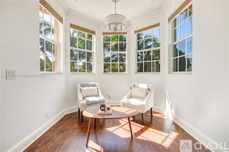 A sunny room with a table and two chairs.