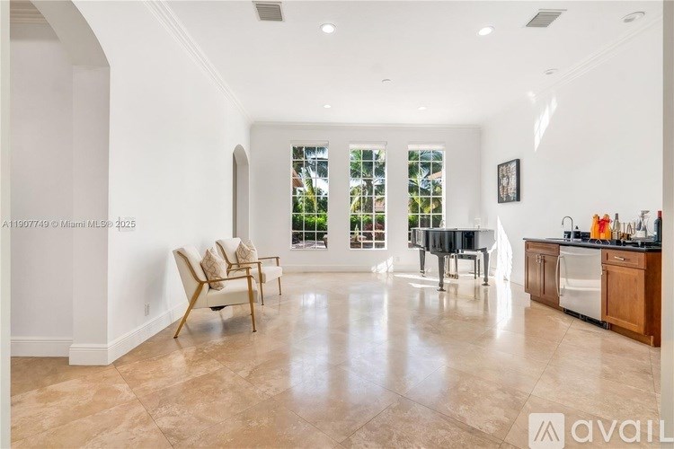 A spacious kitchen and living room with a large window and a dining table.