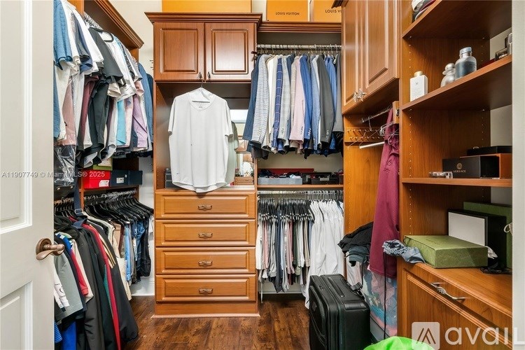 A well-organized walk-in closet with clothes and shelves.
