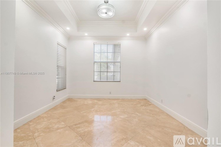 A room with a tiled floor and a window with blinds.