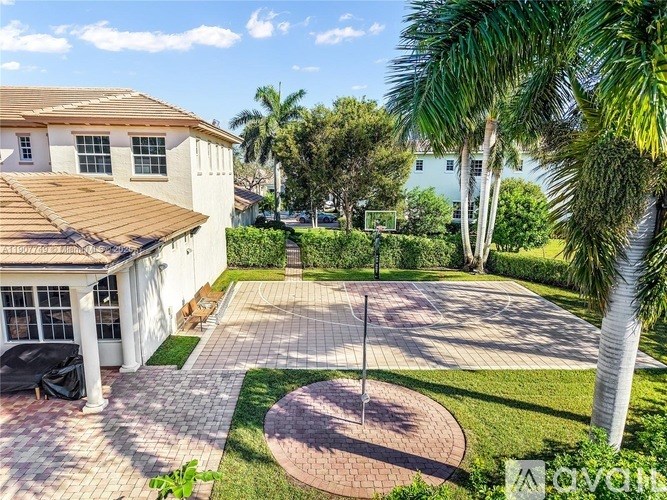 A house with a patio and palm trees in the background.