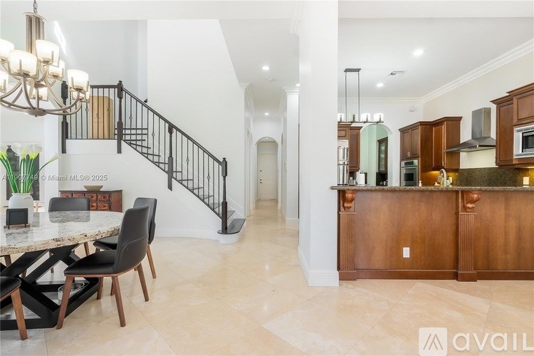 A modern kitchen with a wooden island and a dining table with chairs.
