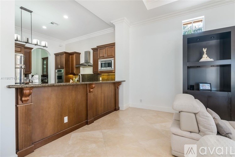 A modern kitchen with wooden cabinets and a marble countertop.