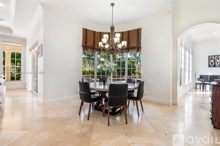 A dining room with a table set for four.