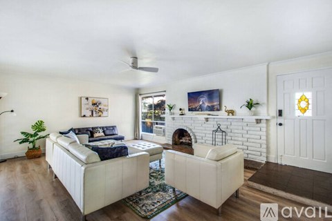 A living room with a fireplace and a couch.