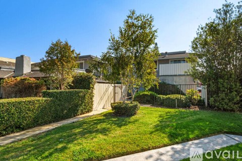 A sunny day in a residential area with a clear blue sky.