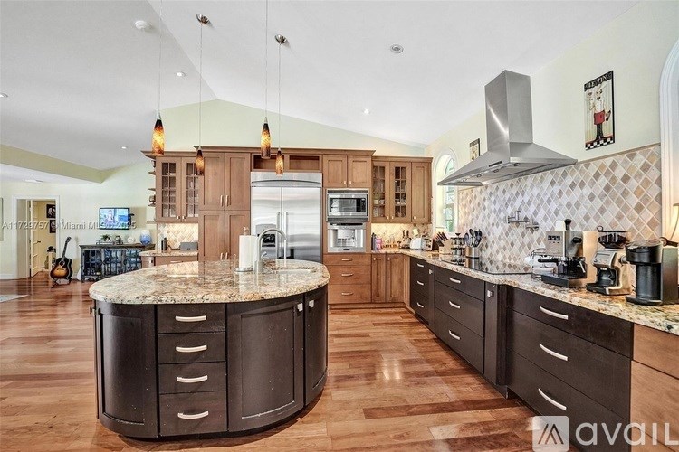 A kitchen with a large island in the middle.