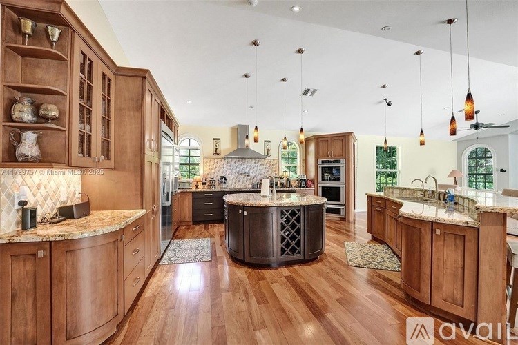 A kitchen with wooden cabinets and a central island.
