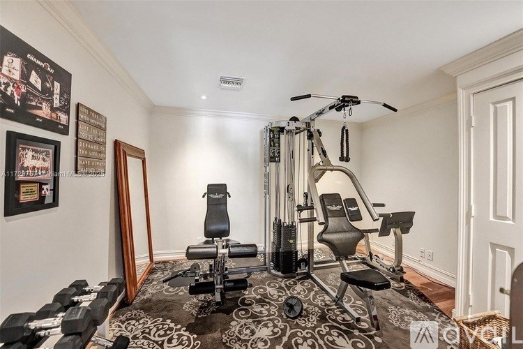 A home gym with a variety of equipment including a stationary bike, a rowing machine, and dumbbells.