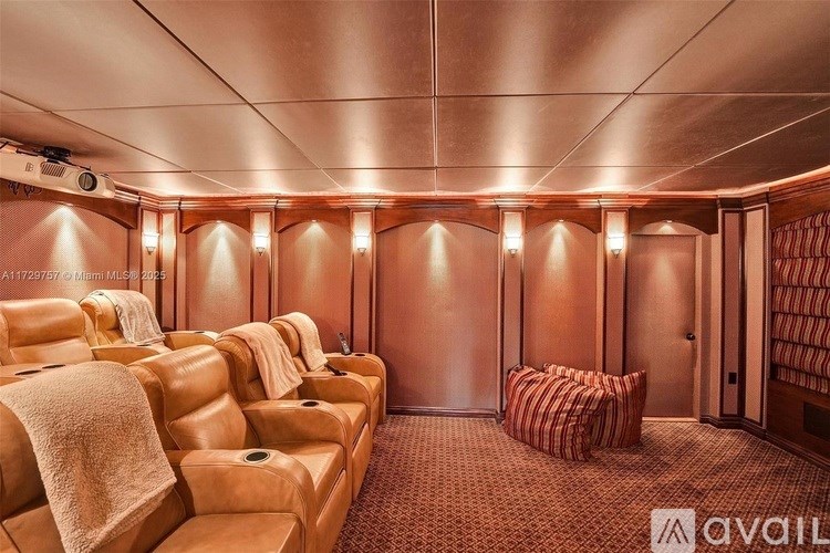 A row of leather seats with towels draped over the backs are lined up in a room with recessed lighting.