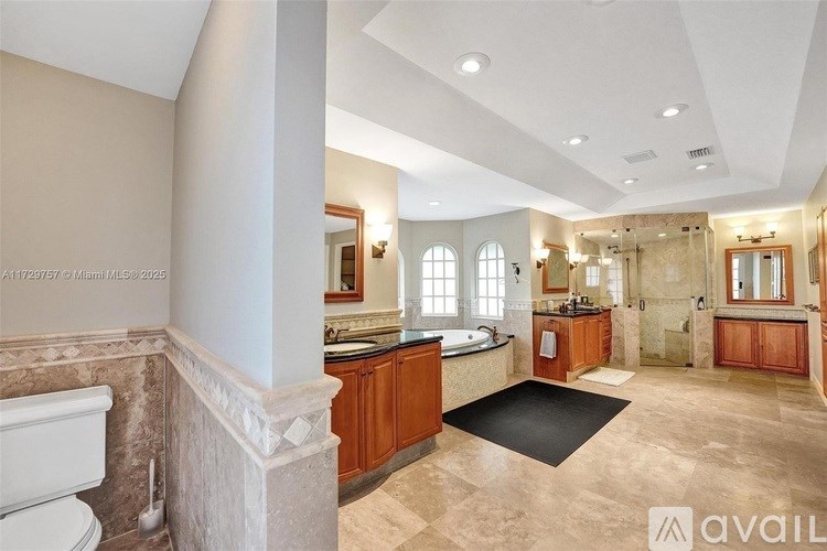 A bathroom with a tub, sink, and mirror.