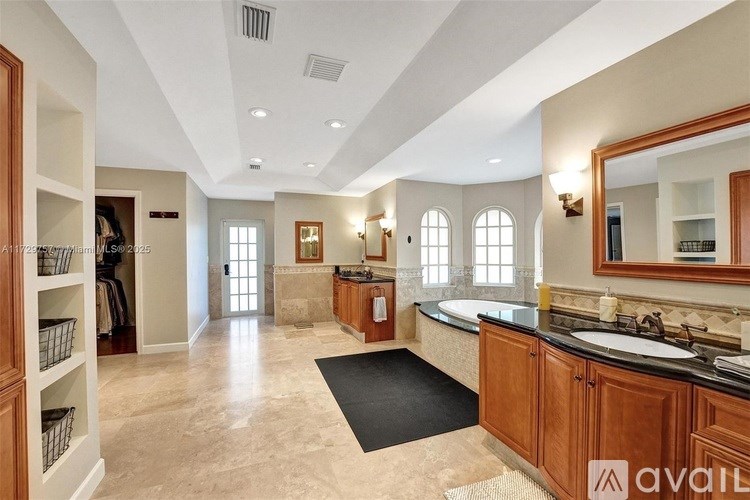 A spacious kitchen with wooden cabinets and a large island.