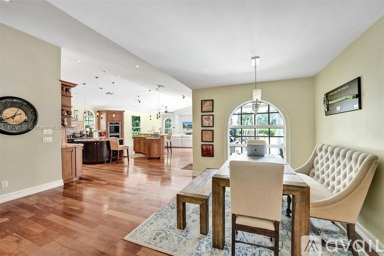 A dining room with a table and chairs is shown.