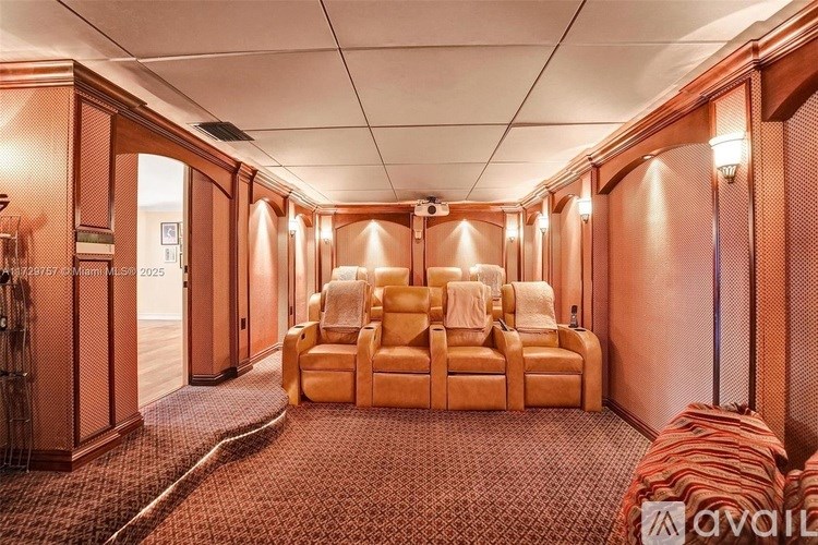 A room with a row of chairs and a carpeted floor.