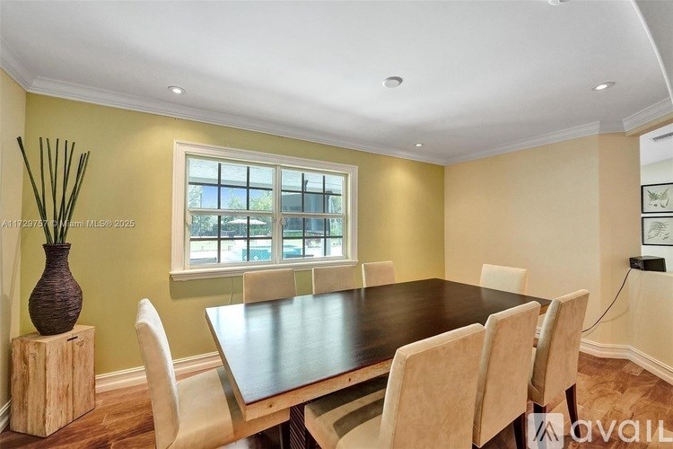 A dining room with a wooden table and chairs.