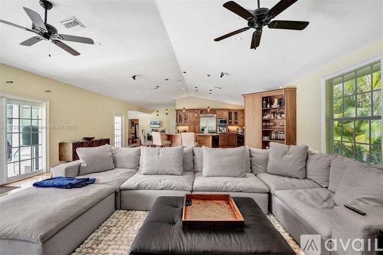 A living room with a grey sofa and a black coffee table.