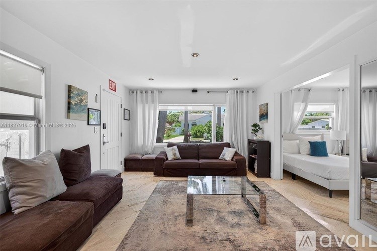 A modern living room with a brown sofa and a glass coffee table.