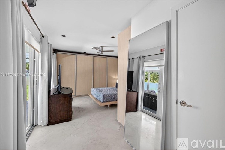 A bedroom with a bed, dresser, and mirror is available for rent.