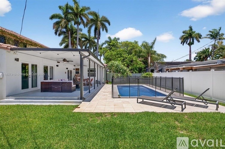A house with a pool and a fence.