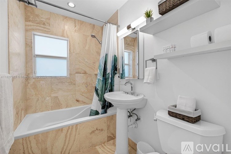 A bathroom with a tub, sink, and toilet.