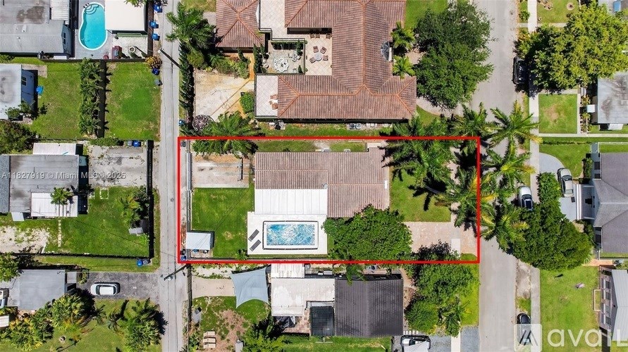 A bird's eye view of a property with a red outlined area.