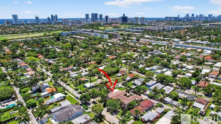 A red arrow points to a house in a suburban neighborhood.