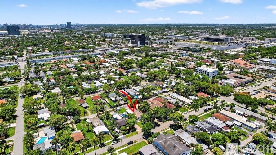 A red arrow is pointing to a building in a residential area.