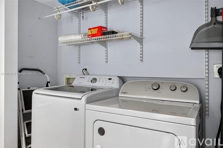 A white washing machine and dryer in a small laundry room.