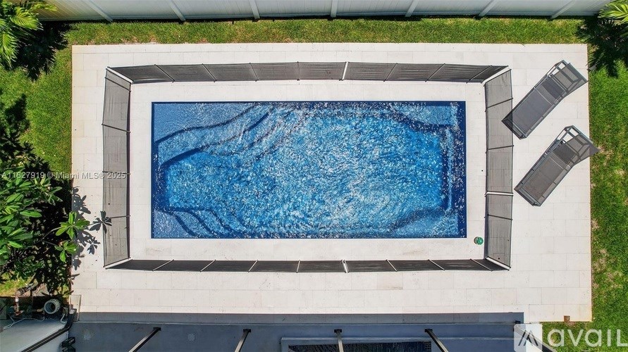 A rectangular pool with a white border and a blue water surface.