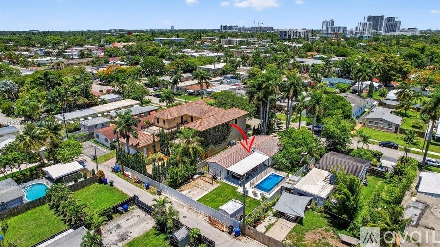 A red arrow points to a house in a suburban neighborhood.