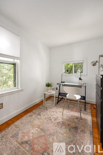 A room with a desk and chair in it.