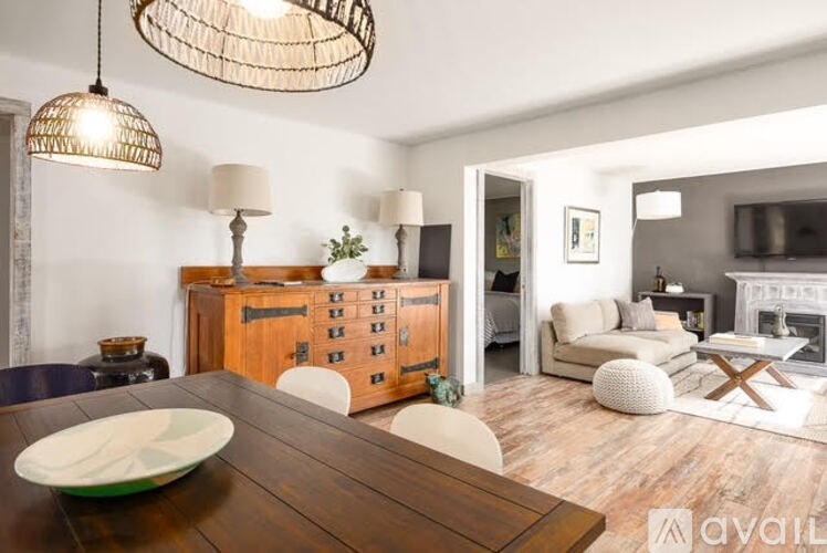 A modern dining room with a wooden table and a green plate on it.