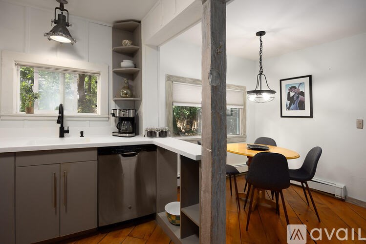 A kitchen with a table and chairs in the middle of it.
