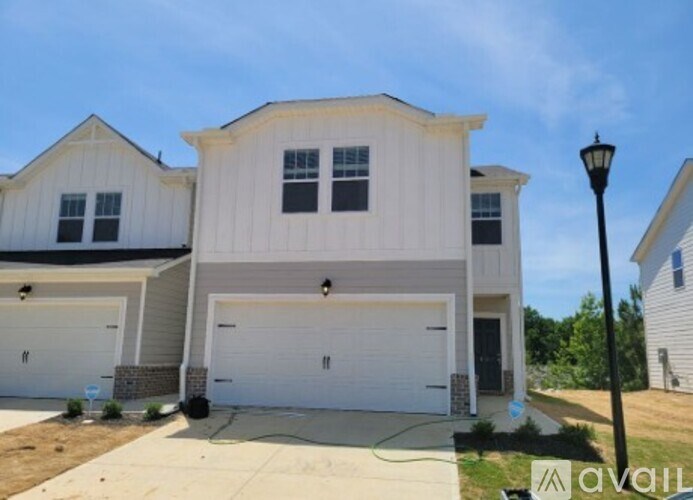 A two-story house with a garage is available for sale.