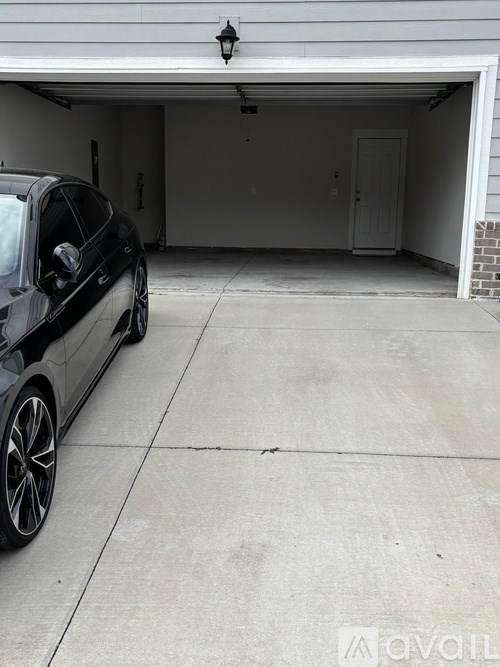 A black car is parked in a garage.