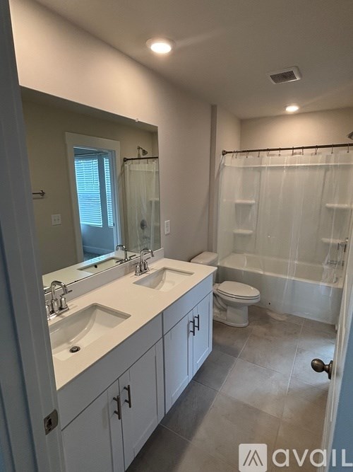 A bathroom with a white sink and a white toilet.
