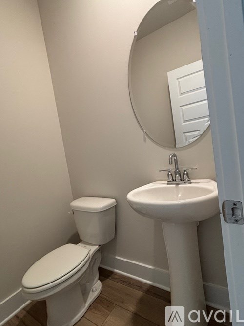 A white toilet sits next to a sink in a small bathroom.