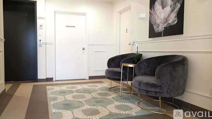 A living room with two chairs and a rug.