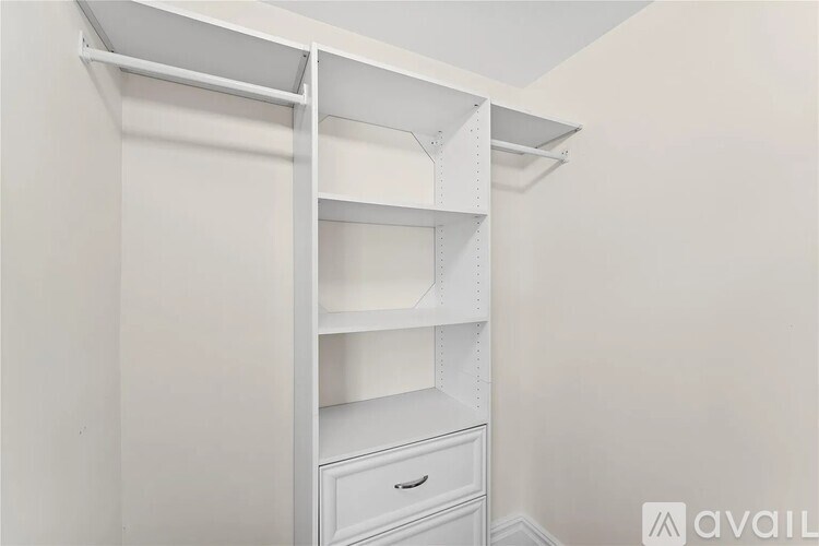 A white closet with shelves and drawers.