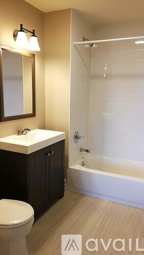 A bathroom with a toilet, sink, and bathtub.