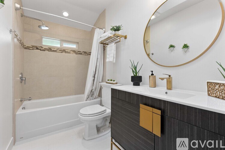 A bathroom with a white tub, toilet, and sink.