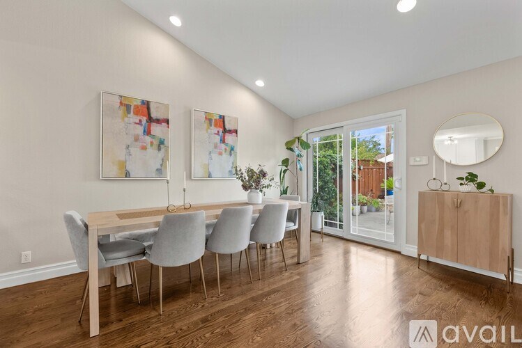 A dining room with a wooden table and chairs.
