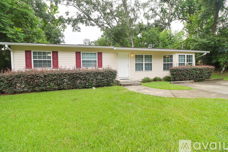 A house with a red window trim is for sale.